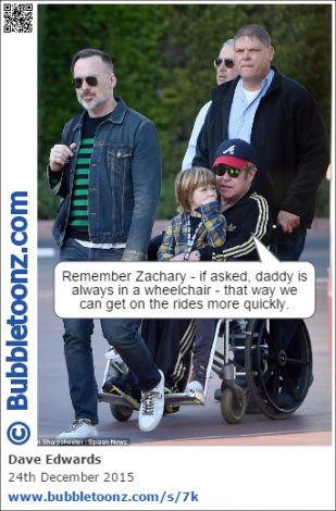 Elton John (in a wheelchair) takes his son Zachary to Disneyland.